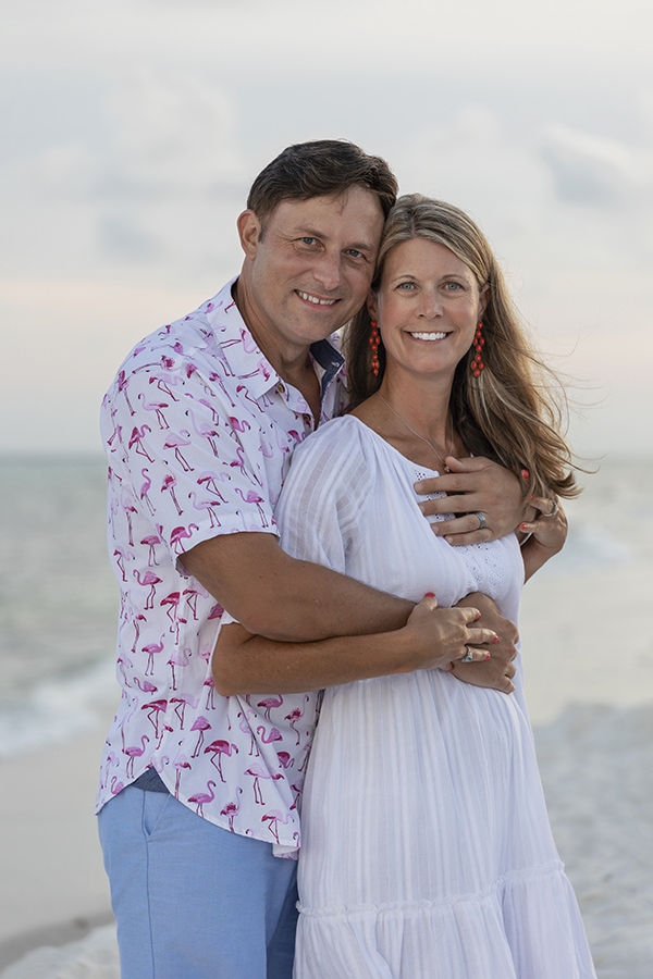 couple pose for family portrait on the beach in navarre